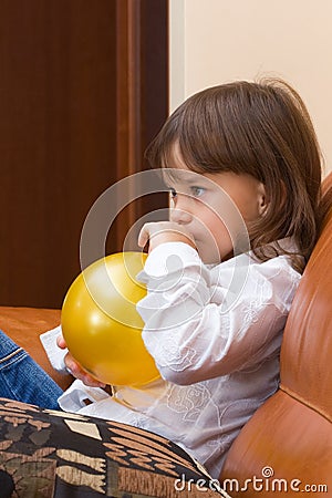 The girl inflates a balloon. Stock Photo