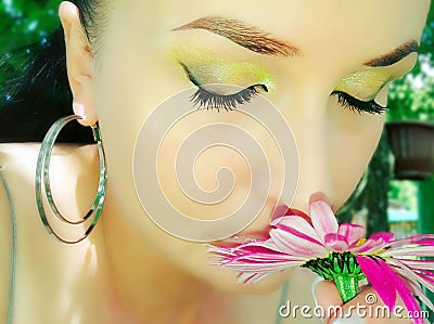 The Girl inhales fragrance of flowers Stock Photo