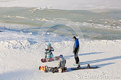 Khabarovsk, Russia - Dec 04, 2016: The girl instructor trains a teenager and a man snowboarding Editorial Stock Photo