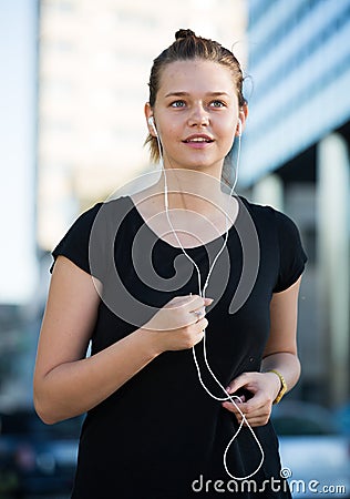 Girl jogging outdoor with music Stock Photo