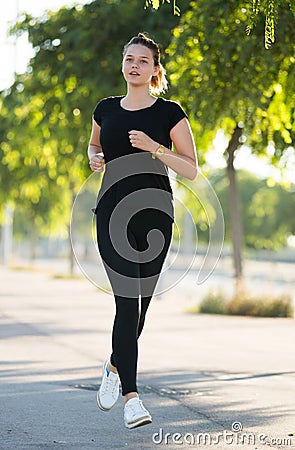 Girl jogging during outdoor workout Stock Photo