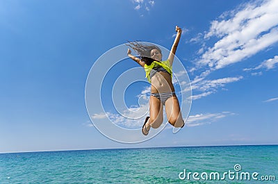 Girl jumping above water horizon Stock Photo