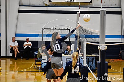 Girl Jumping to Block a Volleyball Editorial Stock Photo