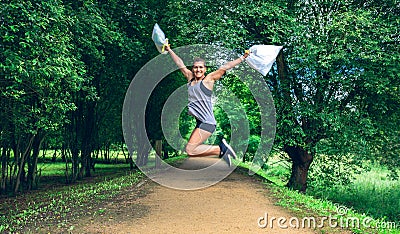 Girl jumping with trash bags after plogging Stock Photo