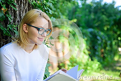 Girl keen on book keep reading. Bestseller top list concept. Woman blonde take break relaxing in park reading book. Girl Stock Photo