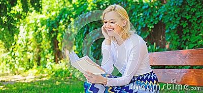 Girl keen on book keep reading. Reading literature as hobby. Girl sit bench relaxing with book, green nature background Stock Photo