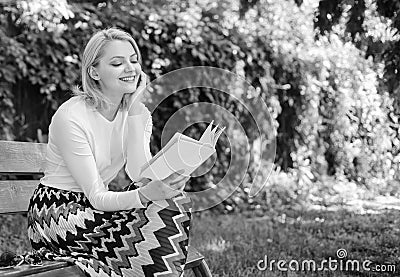 Girl keen on book keep reading. Reading literature as hobby. Woman blonde take break relaxing in park reading book. Girl Stock Photo