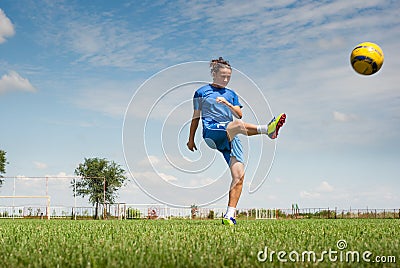 Girl kicking soccer ball Stock Photo