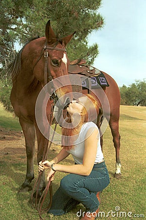 Girl kisses horse Stock Photo