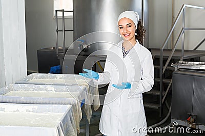 Girl in lab coat at dairy production process Stock Photo