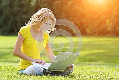 Girl with laptop. Blonde beautiful young woman with notebook Stock Photo