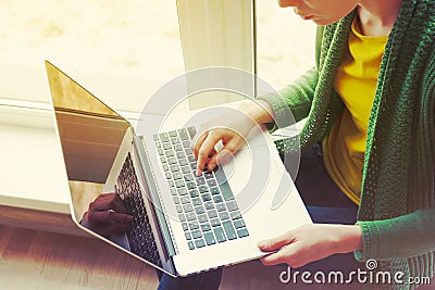 Girl with laptop near window Stock Photo