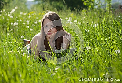 Girl with laptop in a park Stock Photo