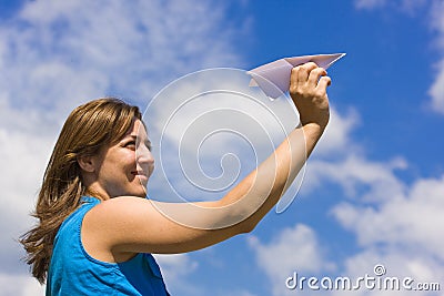 Girl launching a paper plane Stock Photo