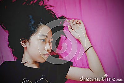 Girl lay on bed with fear Stock Photo