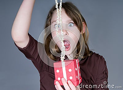 Girl surprised opening present Stock Photo