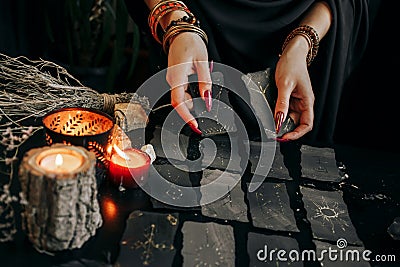 The woman& x27;s hands are holding a magic card. Halloween Stock Photo