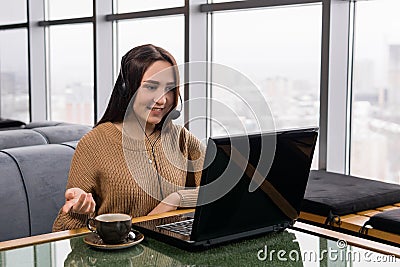 Girl leads some online broadcast from the coffee shop and talks with listeners Stock Photo