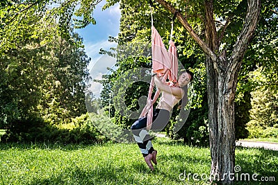 girl with lean figure type decided to practice yoga exercises in t open air in good weather. Stock Photo