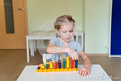Girl learning to add and subtract accounts. Stock Photo