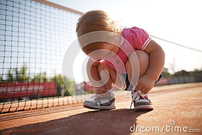 Girl learning to tie shoelaces Stock Photo