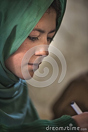 Girl learning in the only school in the village of Shimshal 3100m is a government school taught by teachers based in the village Editorial Stock Photo