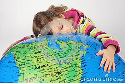 Girl lies on big inflatable globe and embracing it Stock Photo