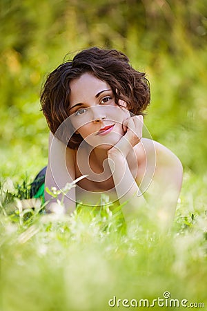 Girl lies on lawn Stock Photo