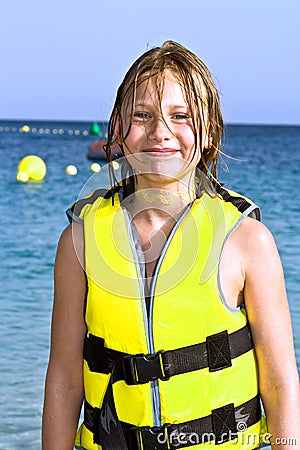 Girl with life vest at the beach Stock Photo