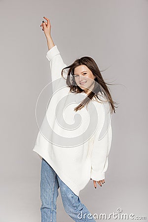 Girl in light jeans and a white oversized sweater Stock Photo