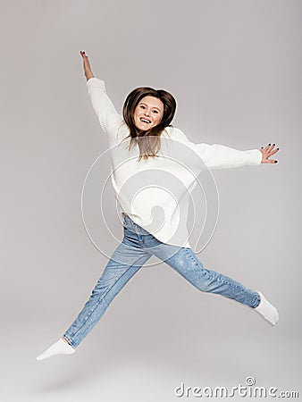 Girl in light jeans and a white oversized sweater Stock Photo