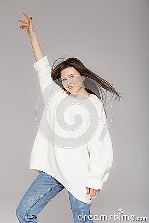 Girl in light jeans and a white oversized sweater Stock Photo