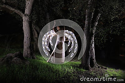 Girl Light Painted in the Desert Under the Night Sky Stock Photo