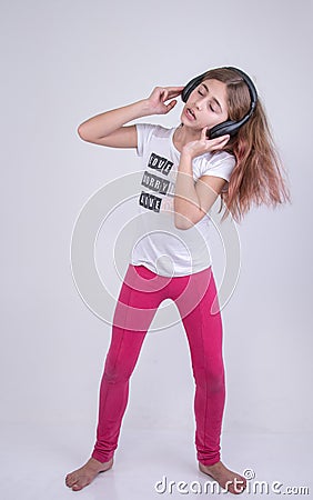 Girl listening singing and dancing a song listening on the headset Stock Photo