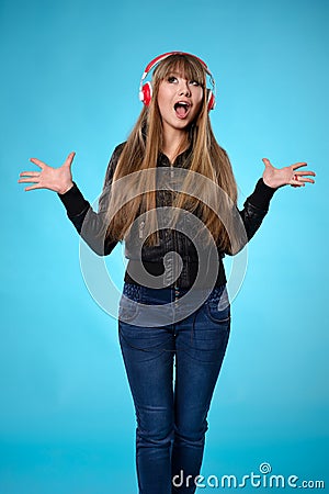 Girl listening to music with big red headphones Stock Photo