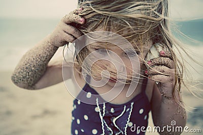 Girl listening to sea shell Stock Photo