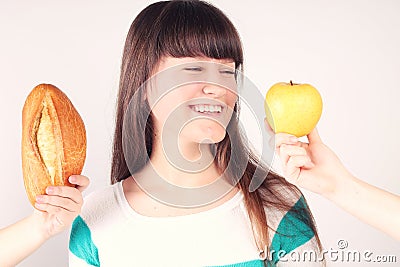 Girl with loaf of bread and apple Stock Photo