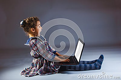 Girl looking computer on a gray background Stock Photo