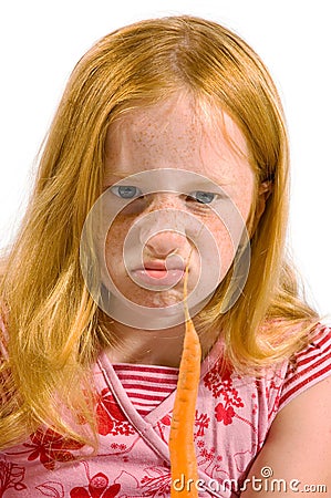 Girl is looking disgusting to a carrot Stock Photo
