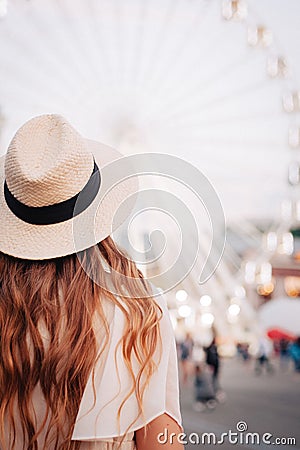 Girl is looking at the Ferris wheel. Ukraine, cotract area Stock Photo