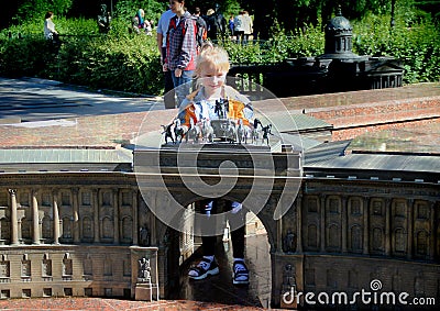 Girl looks at the Biga with six horses over the arch of miniature copies of the General Staff. Editorial Stock Photo