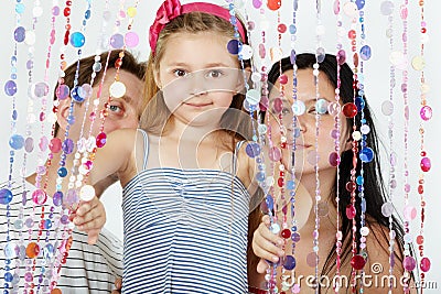 Girl looks, her parents stand behind Stock Photo