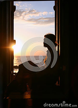 The girl looks at the sea. Stock Photo