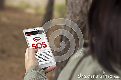 Girl lost in the forest asks for help through an application Stock Photo