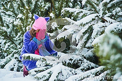 Girl lost in winter forest. lost in the woods and has a frightened face. Child crying in the forest Stock Photo