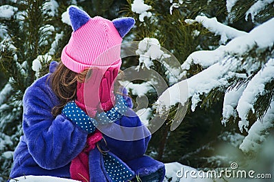 Girl lost in winter forest. lost in the woods and has a frightened face. Child crying in the forest Stock Photo