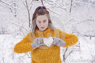 Girl with love snow ball in shape of heart Stock Photo