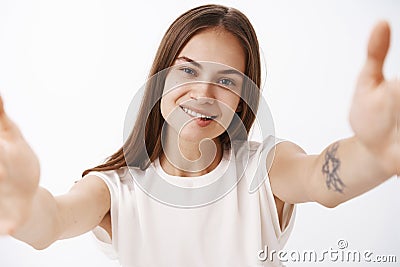 Girl loves being in centre of attention. Confident happy carefree stylish female with straight brown hair and tattoo on Stock Photo