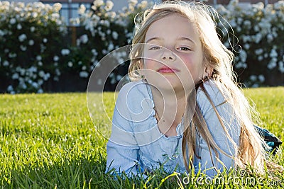 Girl lying in grass Stock Photo