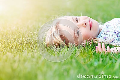 Girl lying in grass Stock Photo